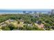 Aerial view featuring luxury homes nestled among lush trees, a tranquil lake, and ocean views in the distance at 10071 Kings Rd., Myrtle Beach, SC 29572