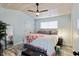 Cozy bedroom with light blue walls, a wood plank ceiling, a ceiling fan, and a comfortable queen-sized bed at 10071 Kings Rd., Myrtle Beach, SC 29572