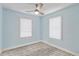 Bright, empty bedroom with blue walls, wood-look floors, and a ceiling fan at 10071 Kings Rd., Myrtle Beach, SC 29572