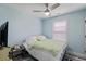 Cozy bedroom featuring light blue walls, a ceiling fan, and a comfortable bed with soft, colorful bedding at 10071 Kings Rd., Myrtle Beach, SC 29572