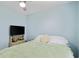 Inviting bedroom showcasing a comfortable bed, soft blue walls, a ceiling fan, and a bright atmosphere at 10071 Kings Rd., Myrtle Beach, SC 29572