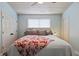 Bedroom with light blue walls, a wood plank ceiling, a ceiling fan, and a comfortable queen-sized bed at 10071 Kings Rd., Myrtle Beach, SC 29572