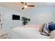 Bedroom with light blue walls, wood plank ceiling, ceiling fan, TV, mirror and comfortable queen-sized bed at 10071 Kings Rd., Myrtle Beach, SC 29572