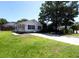 Charming single-story home with white siding, black shutters, and a well-manicured lawn and long driveway at 10071 Kings Rd., Myrtle Beach, SC 29572