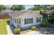 Charming home exterior featuring white siding, dark shutters, a small porch, and well-maintained landscaping at 10071 Kings Rd., Myrtle Beach, SC 29572