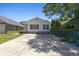 Inviting home exterior featuring white siding, dark shutters, a small porch, and an ample driveway at 10071 Kings Rd., Myrtle Beach, SC 29572