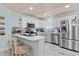 Bright open concept kitchen with stainless steel appliances, light countertops, and an island at 10071 Kings Rd., Myrtle Beach, SC 29572