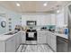 Well-lit kitchen with ample counter space, stainless steel appliances, and white cabinets at 10071 Kings Rd., Myrtle Beach, SC 29572