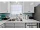 Kitchen sink with stainless steel appliances, white countertops and cabinets, and a window with blinds at 10071 Kings Rd., Myrtle Beach, SC 29572