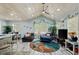 Living room with open floor plan, ceiling fan, many windows, and fresh decor at 10071 Kings Rd., Myrtle Beach, SC 29572