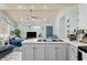Open-concept living space features a kitchen island, and views of the living area and front door at 10071 Kings Rd., Myrtle Beach, SC 29572