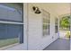 View of a porch featuring a white exterior, light fixture, windows, and fresh paint at 10071 Kings Rd., Myrtle Beach, SC 29572