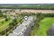 Scenic aerial view of a condo complex featuring parking, greenery, a pond, and partial golf course views at 1009 World Tour Blvd. # 105, Myrtle Beach, SC 29579