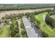 Scenic aerial view of a condo complex featuring parking, greenery, a pond, and partial golf course views at 1009 World Tour Blvd. # 105, Myrtle Beach, SC 29579