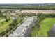 Scenic aerial view of a condo complex featuring parking, greenery, a pond, and partial golf course views at 1009 World Tour Blvd. # 105, Myrtle Beach, SC 29579