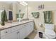 Bathroom with dual sinks, granite countertop, and fresh green towels, reflecting a clean and modern style at 1009 World Tour Blvd. # 105, Myrtle Beach, SC 29579