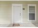 Entrance to condo unit with a white door, adjacent window, and the unit number displayed at 1009 World Tour Blvd. # 105, Myrtle Beach, SC 29579