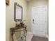 Foyer featuring decorative table with mirror and elegant floral arrangement, next to the unit door at 1009 World Tour Blvd. # 105, Myrtle Beach, SC 29579