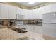 Bright kitchen features white cabinets, granite counters, and stainless steel appliances at 1009 World Tour Blvd. # 105, Myrtle Beach, SC 29579
