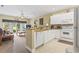 Open kitchen featuring white cabinets, granite countertops, and a view of the living room at 1009 World Tour Blvd. # 105, Myrtle Beach, SC 29579
