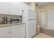 Cozy kitchen area with white cabinets, granite counters, and stainless-steel appliances at 1009 World Tour Blvd. # 105, Myrtle Beach, SC 29579