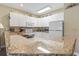 Bright kitchen featuring white cabinets, granite counters, and modern appliances at 1009 World Tour Blvd. # 105, Myrtle Beach, SC 29579