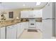 Bright kitchen with white cabinets, granite countertops, and modern appliances at 1009 World Tour Blvd. # 105, Myrtle Beach, SC 29579