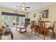 Open living and dining area with neutral carpet, ceiling fan, and access to a back patio at 1009 World Tour Blvd. # 105, Myrtle Beach, SC 29579