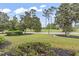 Lush landscaped yard with trees and well-maintained lawn and golf course at 1009 World Tour Blvd. # 105, Myrtle Beach, SC 29579