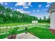 Spacious backyard with a white picket fence and green grass, perfect for outdoor activities at 101 Karlie Ln., Aynor, SC 29511