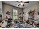 Comfortable bedroom features a ceiling fan, natural light, and a cozy blue patterned rug at 101 Karlie Ln., Aynor, SC 29511