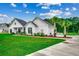 Relax outside with a porch swing surrounded by mulch beds and palm trees on a spacious lawn at 101 Karlie Ln., Aynor, SC 29511