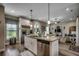 Open-concept kitchen with granite countertops and stainless steel appliances with a view to the living room at 101 Karlie Ln., Aynor, SC 29511