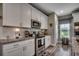 Bright kitchen with stainless steel appliances, granite counters and white cabinetry at 101 Karlie Ln., Aynor, SC 29511