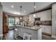 Open kitchen with granite island, pendant lighting, stainless appliances, and eat-in breakfast nook at 101 Karlie Ln., Aynor, SC 29511