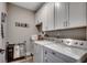 Bright laundry room with granite countertops, white cabinets, washer, and dryer at 101 Karlie Ln., Aynor, SC 29511