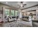 Light living area with a kitchen view, hardwood floors, bright windows and a ceiling fan at 101 Karlie Ln., Aynor, SC 29511