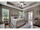 Tranquil main bedroom with a tray ceiling, an ensuite bath, and plenty of natural light at 101 Karlie Ln., Aynor, SC 29511