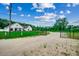 Gated entrance to the property with a long driveway and well-manicured lawn at 101 Karlie Ln., Aynor, SC 29511