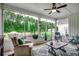 Relaxing screened porch featuring comfortable chairs, outdoor views, and plenty of natural light at 101 Karlie Ln., Aynor, SC 29511
