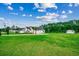 Expansive front yard featuring a well-manicured lawn, home, and treeline at 101 Karlie Ln., Aynor, SC 29511
