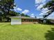 Spacious backyard with lush green grass and mature trees at 109 S Maple Ave., Andrews, SC 29510