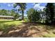 Spacious backyard with mature trees and lush greenery provides a serene outdoor retreat at 109 S Maple Ave., Andrews, SC 29510