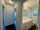 Bright bathroom with a single vanity, large mirror, and view into the hallway at 109 S Maple Ave., Andrews, SC 29510