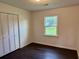 Cozy bedroom with hardwood floors, a window with a green view, and a closet at 109 S Maple Ave., Andrews, SC 29510
