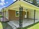 Spacious carport featuring decorative metal support pillars with access to a side entrance and backyard at 109 S Maple Ave., Andrews, SC 29510