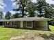 Traditional brick home featuring a covered carport and front entrance in a serene, treed neighborhood at 109 S Maple Ave., Andrews, SC 29510