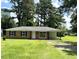 Charming brick home with a well-manicured front yard, mature trees, and a covered carport at 109 S Maple Ave., Andrews, SC 29510