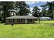 Inviting single-story home with a well-maintained lawn, mature trees, and brick facade at 109 S Maple Ave., Andrews, SC 29510