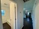 Hallway view with access to a bathroom and kitchen with black appliances and bar seating at 109 S Maple Ave., Andrews, SC 29510